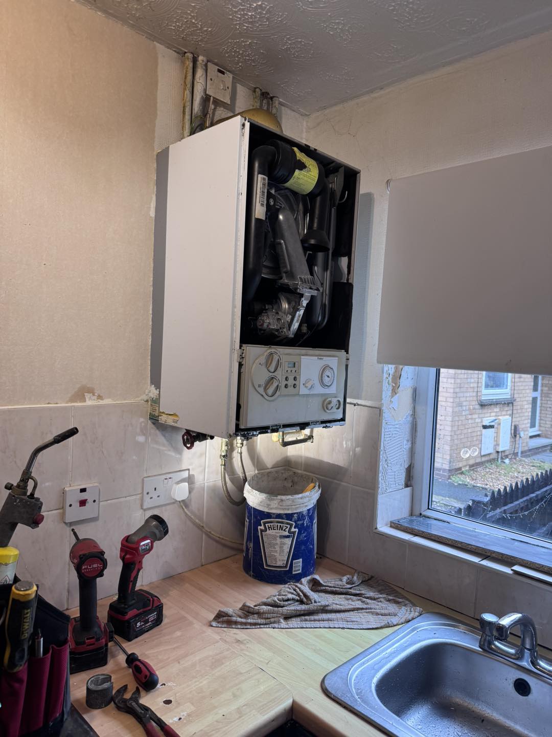 New boiler installed in a kitchen cupboard